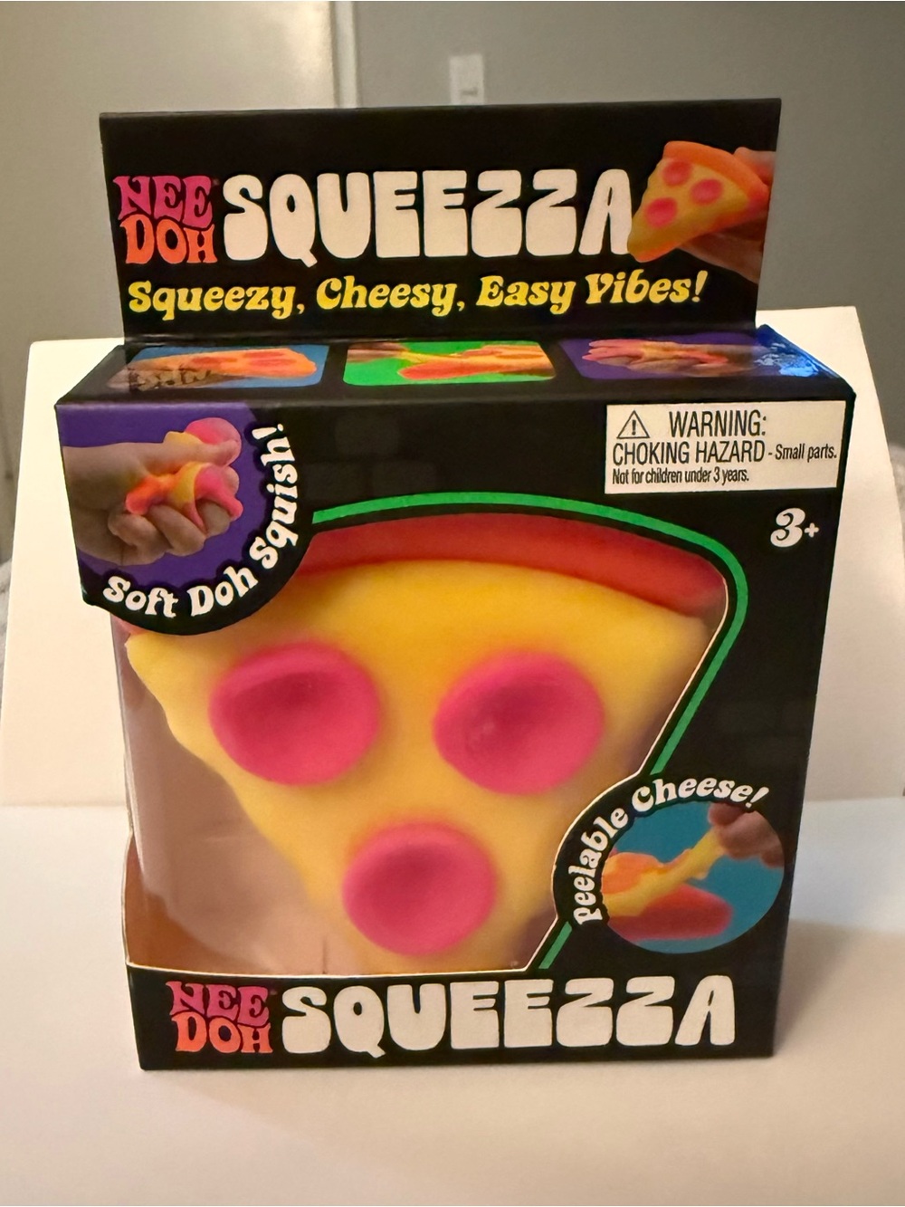 NeeDoh Squeezza Yellow Pizza Slice Squishy Toy with Pink Toppings